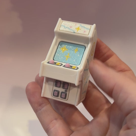 Mini retro arcade machine fidget clicker keychain with pastel color way, blue screen, and 3D printed design, available in clicky or silent.
