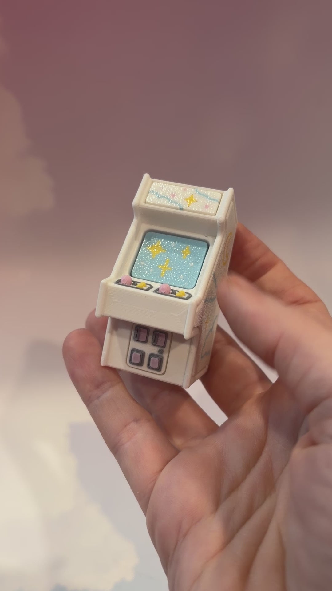 Mini retro arcade machine fidget clicker keychain with pastel color way, blue screen, and 3D printed design, available in clicky or silent.