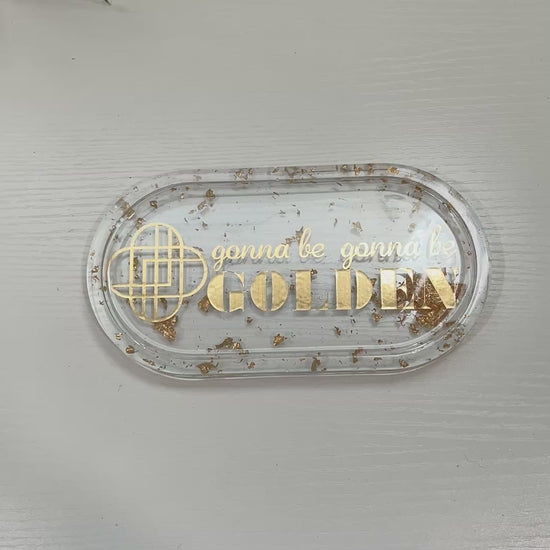 Handmade resin trinket tray with gold leaf and the quote “Gonna Be Gonna Be Golden.” Kpop Demon Hunters–inspired jewelry dish, perfect for gifts or décor.