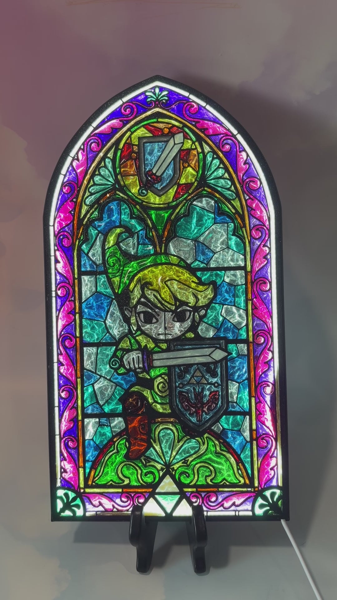 Handmade Zelda-inspired stained glass window light featuring hand-tinted resin artwork in a 3D printed frame with glowing interior LED lighting.