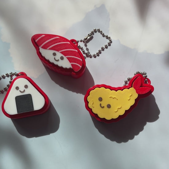 Sushi shaped 3D printed fidget clicker keychain. 
