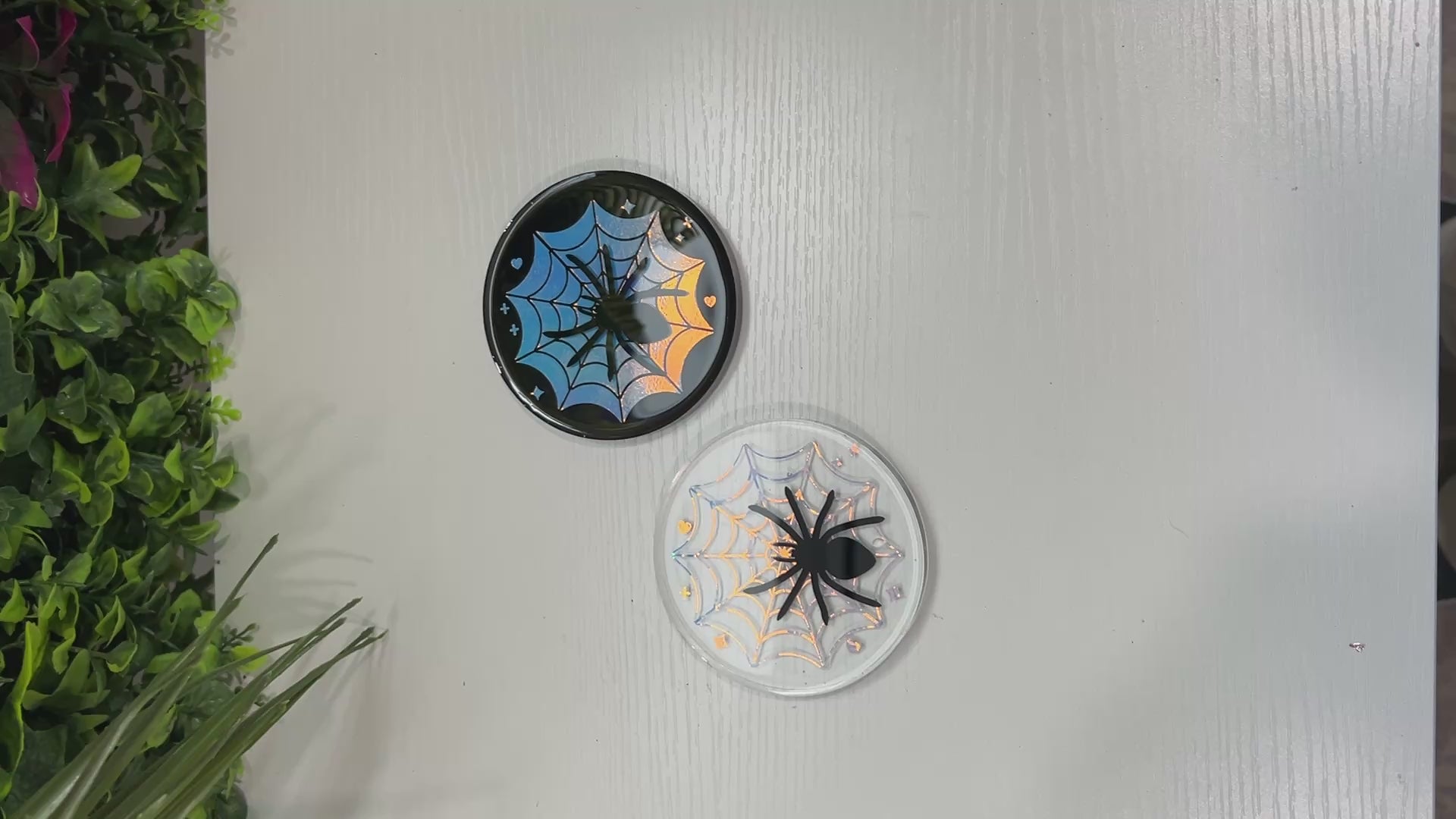 Pastel goth spiderweb coasters featuring a handmade resin design with intricate spiderwebs. Perfect for adding a dark, spooky aesthetic to any home. These unique coasters blend pastel colors with a goth twist, great for goth or Halloween-themed decor