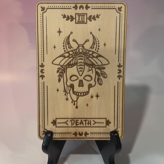 Laser-engraved wooden tarot card made from 3mm basswood, approximately 7 x 5 inches. Available in all 22 Major Arcana designs with customizable colors and an optional display stand for an additional $2.
