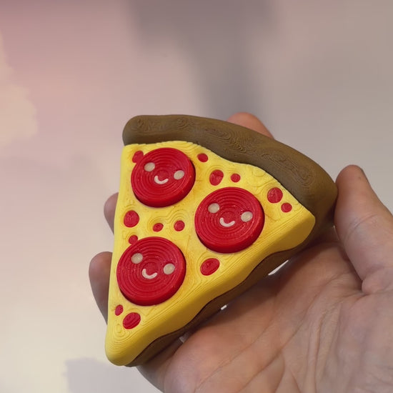 Pizza slice fidget clicker with smiley pepperoni toppings.