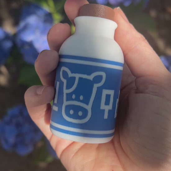 A cute Lon Lon Milk Bottle clicker toy inspired by classic games. 3D printed and handheld, great for fidgeting, gifting, or gamer-themed keychains.