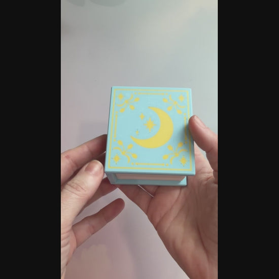 Book-shaped fidget clicker opening to a box of chocolates