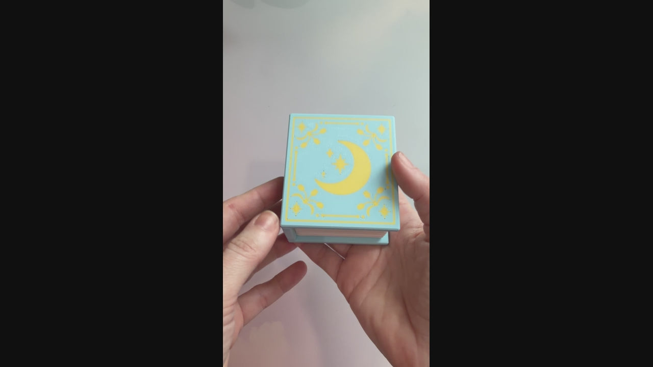 Book-shaped fidget clicker opening to a box of chocolates