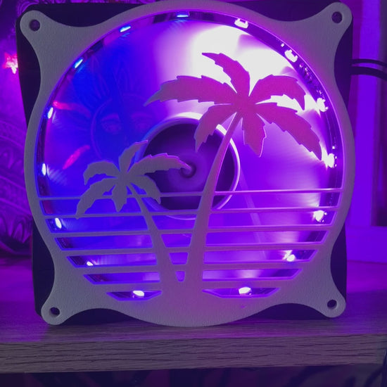 Decorative PC fan cover featuring an 80s tropical palm tree design with a black textured finish. Perfect for adding a unique and stylish touch to gaming or custom PC builds, blending functionality with aesthetic flair.