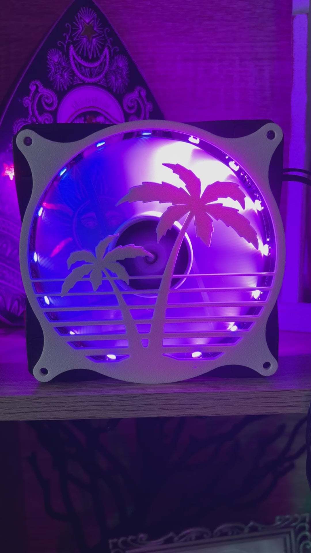 Decorative PC fan cover featuring an 80s tropical palm tree design with a black textured finish. Perfect for adding a unique and stylish touch to gaming or custom PC builds, blending functionality with aesthetic flair.