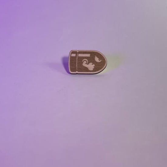 A laser engraved wood pin featuring a stylized Bullet Bill design. Lightweight and handmade, perfect for gamers, pin collectors, and geeky fashion fans.