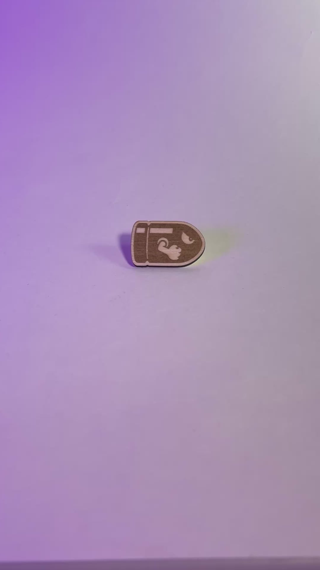 A laser engraved wood pin featuring a stylized Bullet Bill design. Lightweight and handmade, perfect for gamers, pin collectors, and geeky fashion fans.