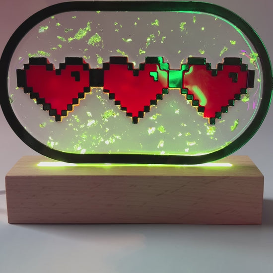 Handmade LED pixel heart container light with a hand-poured resin panel, silver leaf accents, laser-cut acrylic hearts, and customizable RGB lighting.