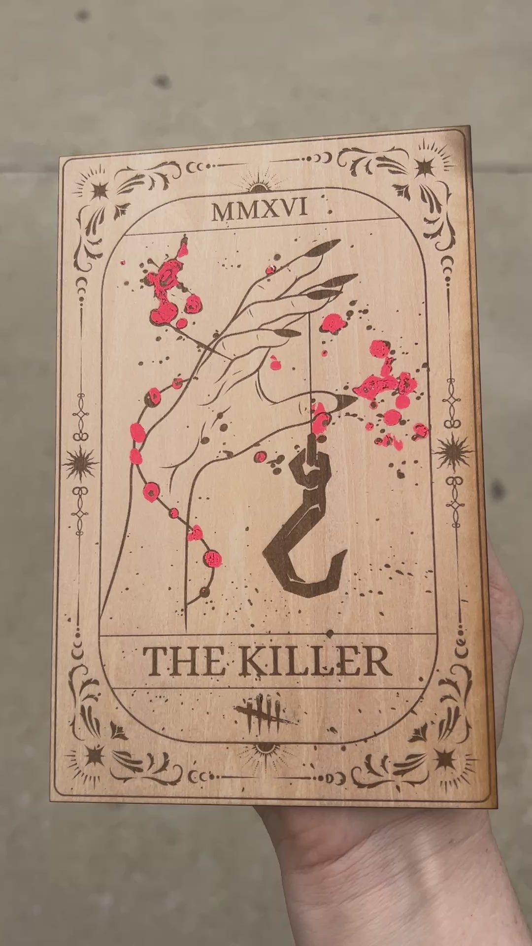 Laser engraved wooden tarot card featuring “The Killer” inspired by Dead by Daylight with red foiled accents. Horror-themed gamer decor perfect for fans of spooky games and tarot.