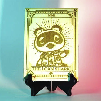 Laser-engraved wooden tarot card featuring Tom Nook as "The Loan Shark." Inspired by Animal Crossing, perfect for gamers, tarot lovers, and collectors. Cottagecore, cozy gaming decor.